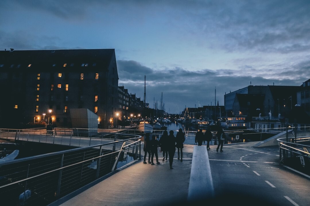 Cyclists crossing a bridge in Copenhagen at sunset