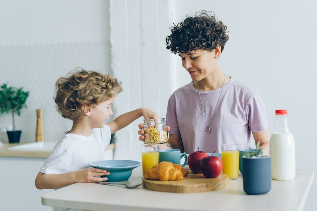 Danish family having breakfast together in a bright kitchen